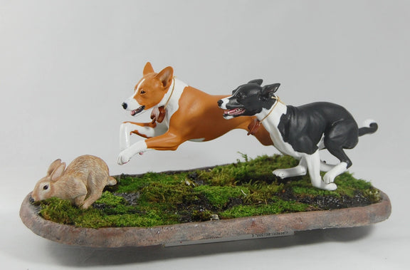 Basenjis chasing a rabbit