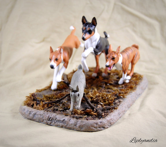 Basenjis chasing a rabbit