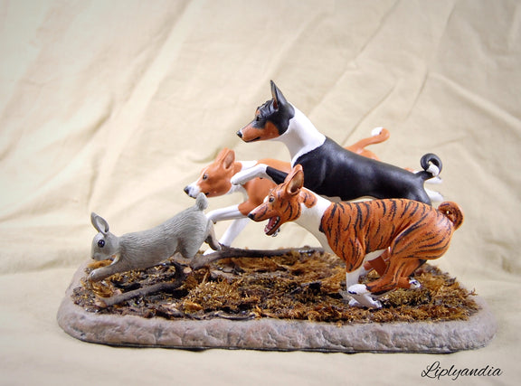 Basenjis chasing a rabbit